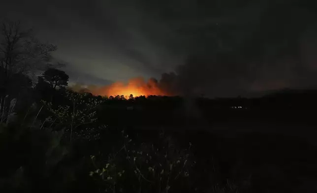 Smoke rises from a wildfire early Wednesday, April 23, 2025, near Barnegat Township, N.J. (AP Photo/Chris Szagola)