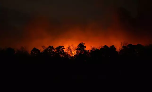 Smoke rises from a wildfire early Wednesday, April 23, 2025, near Barnegat Township, N.J. (AP Photo/Chris Szagola)