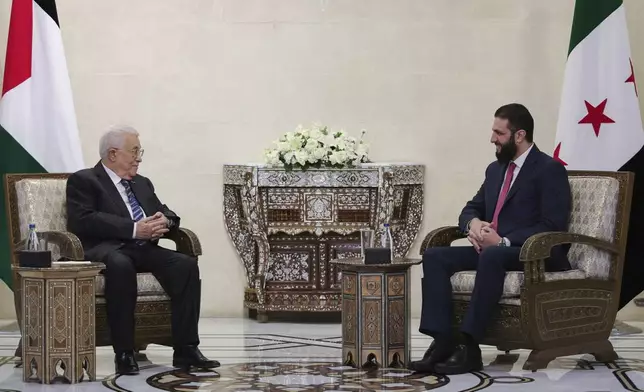 In this photo released by the Syrian Presidency press office, Syrian President Ahmad al-Sharaa, right, meets with Palestinian Authority President Mahmoud Abbas in Damascus, Syria, Friday, April 18, 2025. (Syrian Presidency press office via AP)