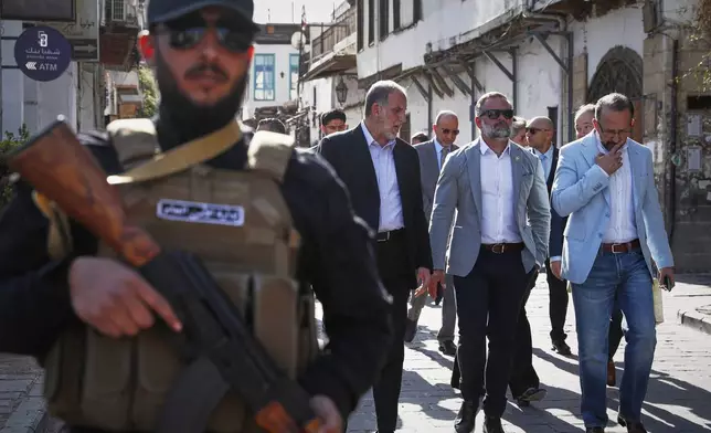Accompanied by unidentified members of the delegation, U.S. congressman Cory Mills (R-FL), second from right, walks in the Old City of Damascus Friday, April 18, 2025. Mills is in Damascus in an unofficial visit organized by a Syrian-American nonprofit, the first visit by U.S. legislators since the fall of former Syrian President Bashar Assad in December.(AP Photo/Omar Sanadiki)