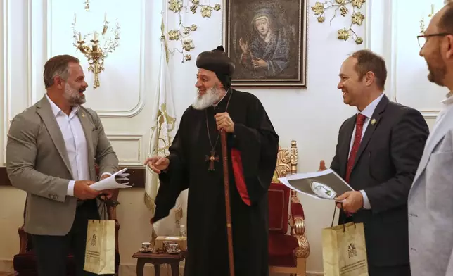 U.S. congressmen Cory Mills (R-FL), left, and Martin Stutzman (R-IN), second from right, meet Mor Ignatius Aphrem II, a Syrian-American Christian prelate serving as the Patriarch of the Syriac Orthodox Church in Damascus Friday, April 18, 2025. Mills and Stutzman arrived on an unofficial visit organized by a Syrian-American nonprofit, the first visit by U.S. legislators since the fall of former Syrian President Bashar Assad in December.(AP Photo/Omar Sanadiki)