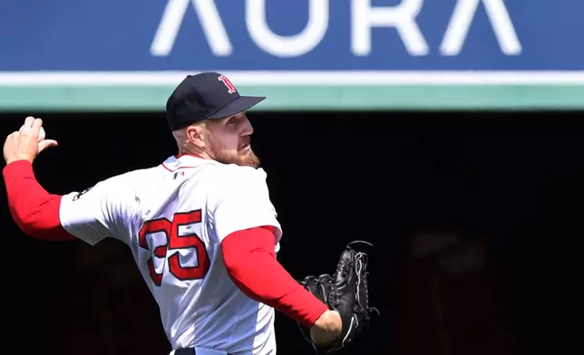 Boston Red Sox's Kristian Campbell, left, bumps gloves with manager Alex Cora before a baseball game against the Toronto Blue Jays, Thursday, April 10, 2025, in Boston. (AP Photo/Jim Davis)
