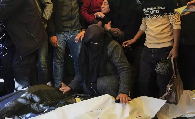 Relatives Mourn over the bodies of 10 members of the Abu Al-Rous family, killed when an Israeli airstrike struck their displacement tent overnight, during their funeral in Khan Younis, southern Gaza Strip, Thursday, April 17, 2025. (AP Photo/Abdel Kareem Hana)