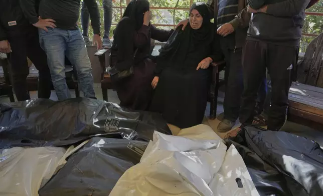 Relatives Mourn over the bodies of 10 members of the Abu Al-Rous family, killed when an Israeli airstrike struck their displacement tent overnight, during their funeral in Khan Younis, southern Gaza Strip, Thursday, April 17, 2025. (AP Photo/Abdel Kareem Hana)