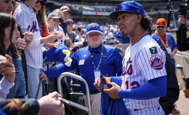 New York Mets shortstop Francisco Lindor (12) signs baseballs for fans before a baseball game against the St. Louis Cardinals, Sunday, April 20, 2025, in New York. (AP Photo/Angelina Katsanis)