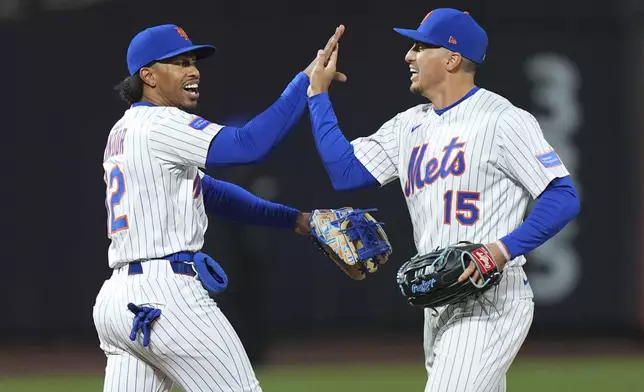 New York Mets' Francisco Lindor (12) celebrates with Tyrone Taylor (15) after a baseball game against the Philadelphia Phillies Monday, April 21, 2025, in New York. (AP Photo/Frank Franklin II)