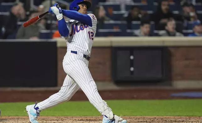 New York Mets' Francisco Lindor (12) follows through on a three-run home run during the seventh inningof a baseball game against the Philadelphia Phillies Monday, April 21, 2025, in New York. (AP Photo/Frank Franklin II)