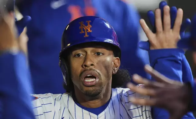 New York Mets' Francisco Lindor celebrates with teammates after hitting a home run during the first inning of a baseball game against the Philadelphia Phillies Monday, April 21, 2025, in New York. (AP Photo/Frank Franklin II)
