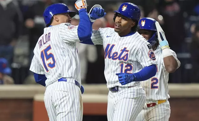 New York Mets' Francisco Lindor (12) celebrates with teammates Tyrone Taylor (15) ad Luisangel Acuña (2) after they scored on a three-run home run during the seventh inning of a baseball game against the Philadelphia Phillies Monday, April 21, 2025, in New York. (AP Photo/Frank Franklin II)