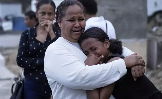Family and friends grieve during the burial service of Marilenny Pilarte who died at the Jet Set nightclub when its roof collapsed, in Haina, Dominican Republic, Thursday, April 10, 2025. (AP Photo/Matias Delacroix)