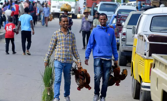Traders trade live chickens in a street market a day before Ethiopian Orthodox Christians celebrate Easter Sunday in Addis Ababa, Ethiopia Saturday, April 19, 2025. (AP Photo)