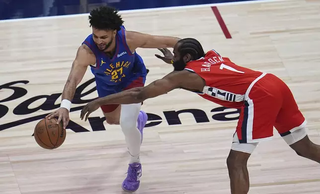 Denver Nuggets guard Jamal Murray, left, drives past Los Angeles Clippers guard James Harden in the first half of Game 1 of an NBA first-round playoff series Saturday, April 19, 2025, in Denver. (AP Photo/David Zalubowski)