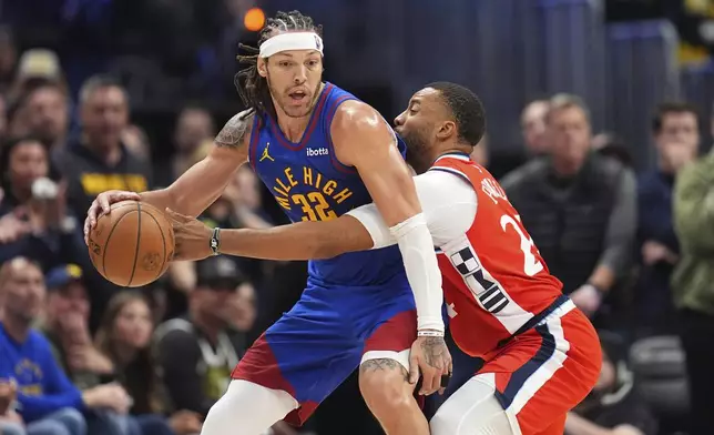 Denver Nuggets forward Aaron Gordon, left, looks to pass the ball as Los Angeles Clippers guard Norman Powell, right, defends in overtime of Game 1 of an NBA first-round playoff series Saturday, April 19, 2025, in Denver. (AP Photo/David Zalubowski)