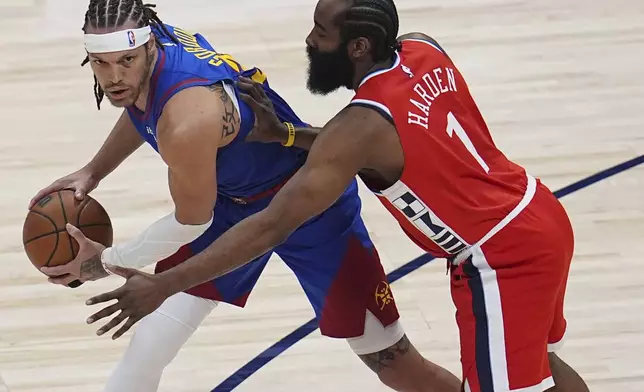 Denver Nuggets forward Aaron Gordon, left, looks to pass the ball as Los Angeles Clippers guard James Harden, right, defends in the first half of Game 1 of an NBA first-round playoff series Saturday, April 19, 2025, in Denver. (AP Photo/David Zalubowski)