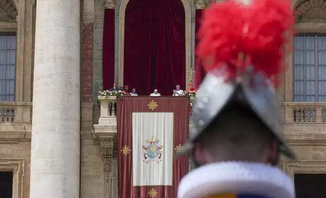 Pope Francis appears on the central lodge of St. Peter's Basilica to bestow the Urbi et Orbi (Latin for to the city and to the world) blessing at the end of the Easter mass presided over by Cardinal Angelo Comastri in St. Peter's Square at the Vatican Sunday, April 20, 2025. (AP Photo/Andrew Medichini)