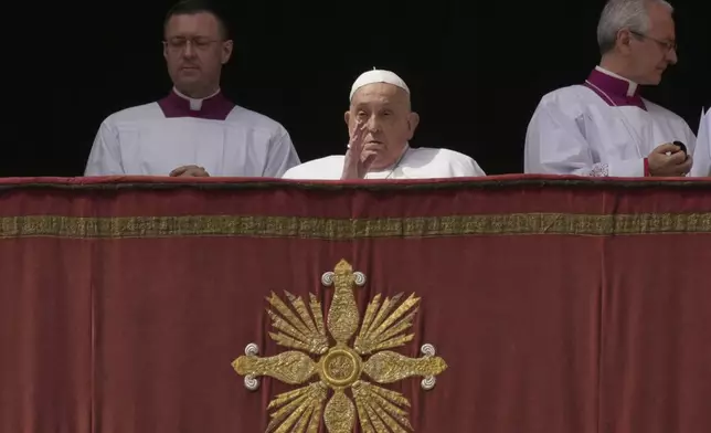Pope Francis appears on the central lodge of St. Peter's Basilica to bestow the Urbi et Orbi (Latin for to the city and the world) blessing at the end of the Easter mass presided over by Cardinal Angelo Comastri in St. Peter's Square at the Vatican Sunday, April 20, 2025. (AP Photo/Andrew Medichini)