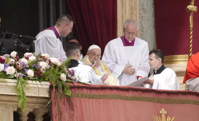 Pope Francis bestows the Urbi et Orbi (Latin for to the city and to the world) blessing from the central lodge of St. Peter's Basilica at the end of the Easter mass presided over by Cardinal Angelo Comastri in St. Peter's Square at the Vatican Sunday, April 20, 2025. (AP Photo/Gregorio Borgia)