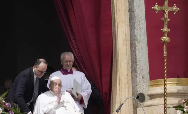 Pope Francis bestows the Urbi et Orbi (Latin for to the city and to the world) blessing from the central lodge of St. Peter's Basilica at the end of the Easter mass presided over by Cardinal Angelo Comastri in St. Peter's Square at the Vatican Sunday, April 20, 2025. (AP Photo/Gregorio Borgia)