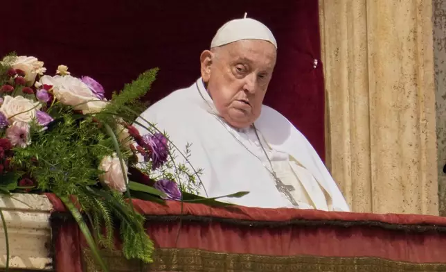 Pope Francis appears on the central lodge of St. Peter's Basilica to bestow the Urbi et Orbi (Latin for to the city and the world) blessing at the end of the Easter mass in St. Peter's Square at the Vatican Sunday, April 20, 2025. Francis died Monday, April 21, 2025. (AP Photo/Gregorio Borgia)