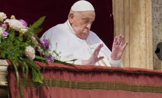 Pope Francis appears on the central lodge of St. Peter's Basilica to bestow the Urbi et Orbi (Latin for to the city and the world) blessing at the end of the Easter mass in St. Peter's Square at the Vatican Sunday, April 20, 2025. Francis died Monday, April 21, 2025. (AP Photo/Gregorio Borgia)