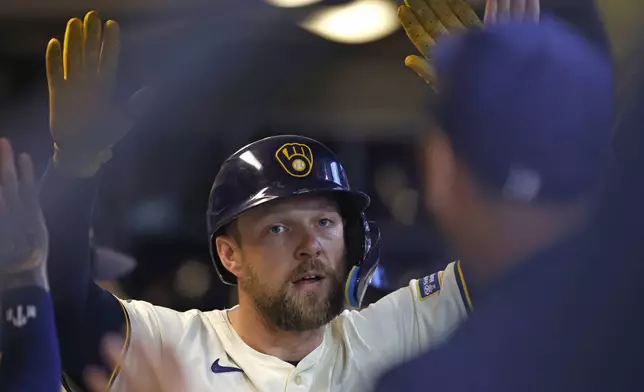 Milwaukee Brewers' Rhys Hoskins reacts after his home run against the Detroit Tigers during the third inning of a baseball game, Wednesday, April 16, 2025, in Milwaukee. (AP Photo/Jeffrey Phelps)