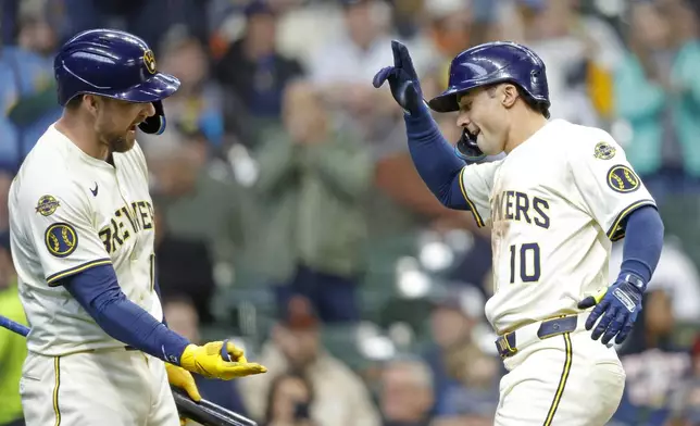 Milwaukee Brewers' Sal Frelick (10) reacts with Rhys Hoskins after Felick's home run against the Detroit Tigers during the sixth inning of a baseball game, Wednesday, April 16, 2025, in Milwaukee. (AP Photo/Jeffrey Phelps)
