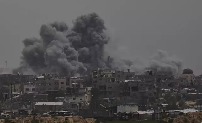 Smoke rises to the sky following an Israeli bombardment in Khan Younis, Gaza Strip, Thursday, April 24, 2025. (AP Photo/Abdel Kareem Hana)