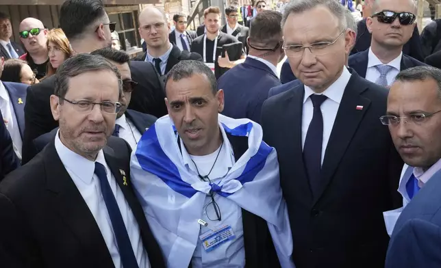 Poland's President Andrzej Duda, right, and his Israel's counterpart Isaac Herzog arrive at the former Nazi German death camp of Auschwitz-Birkenau to attend the "March of the Living", the annual Holocaust remembrance event in memory of the six million Holocaust victims in Oswiecim, Poland, Thursday, April 24, 2025. (AP Photo/Czarek Sokolowski)