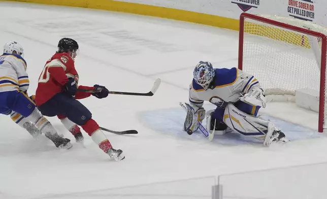 Buffalo Sabres goaltender Ukko-Pekka Luukkonen (1) stops a shot on goal by Florida Panthers center Jesper Boqvist (70) during overtime at an NHL hockey game, Saturday, April 12, 2025, in Sunrise, Fla. (AP Photo/Marta Lavandier)