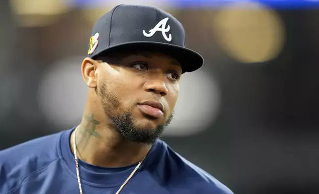 FILE - Atlanta Braves' Ronald Acuna Jr. stands in the dugout during the fifth inning of a baseball game against the Los Angeles Angels, on Aug. 17, 2024, in Anaheim, Calif. (AP Photo/Ryan Sun, File)