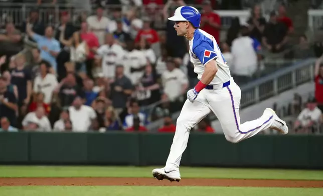 Atlanta Braves outfielder Jarred Kelenic (24) runs the bases against the Minnesota Twins trying to get to second base during the sixth inning in a baseball game at Truist Park, Saturday, April 19, 2025, in Atlanta. (AP Photo/ John David Mercer)