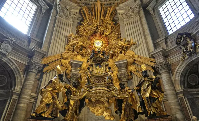 The recent restoration of Bernini's Cathedra Petriis is displayed to journalists inside St. Peter's Basilica at the Vatican, Friday, April 11, 2025. (AP Photo/Gregorio Borgia)