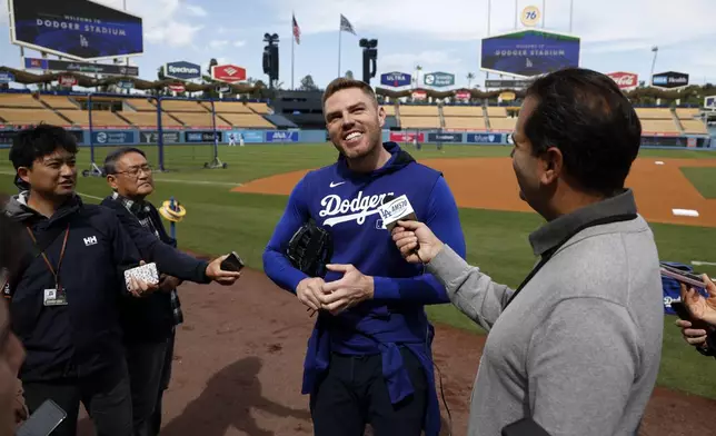 Los Angeles Dodgers' Freddie Freeman speaks to reporters during batting practice before a baseball game against the Atlanta Braves, Tuesday, April 1, 2025, in Los Angeles. (AP Photo/Kevork Djansezian)