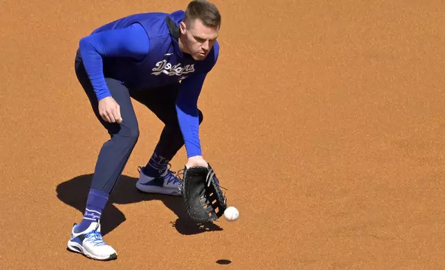 Los Angeles Dodgers first baseman Freddie Freeman warms up prior to a baseball game against the Chicago Cubs, Friday, April 11, 2025, in Los Angeles. (AP Photo/Jayne Kamin-Oncea)