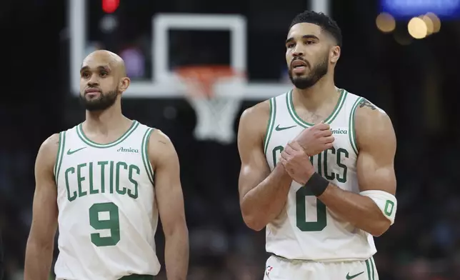 Boston Celtics' Jayson Tatum (0), right, reacts beside Derrick White after falling on a flagrant fowl by Orlando Magic's Kentavious Caldwell-Pope during the second half in Game 1 of a first-round NBA playoff basketball series Sunday, April 20, 2025, in Boston. (AP Photo/Michael Dwyer)
