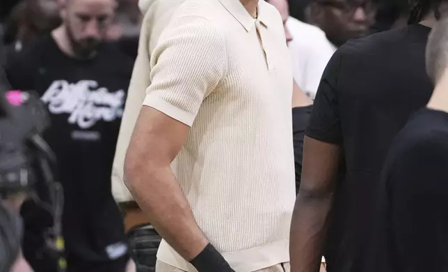 Boston Celtics forward Jayson Tatum, who is sidelined with an injury, stands near the bench with his wrist wrapped during the first half in game 2 of a first-round NBA playoff basketball series against the Orlando Magic, Wednesday, April 23, 2025, in Boston. (AP Photo/Charles Krupa)