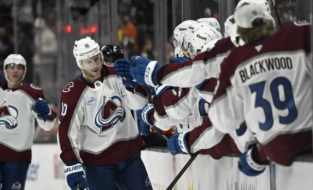 Colorado Avalanche center Charlie Coyle (10) celebrates with teammates after scoring against the Anaheim Ducks during the third period of an NHL hockey game in Anaheim, Calif., Sunday, April 13, 2025. (AP Photo/Alex Gallardo)