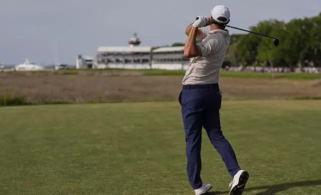 Scottie Scheffler watches his drive from the 18th tee during the final round of the RBC Heritage golf tournament, Sunday, April 20, 2025, in Hilton Head Island, S.C. (AP Photo/Mike Stewart)