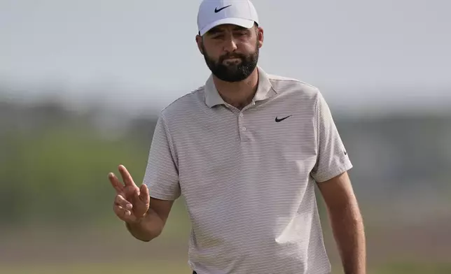 Scottie Scheffler waves to the gallery after making a putt on the 18th hole during the final round of the RBC Heritage golf tournament, Sunday, April 20, 2025, in Hilton Head Island, S.C. (AP Photo/Mike Stewart)