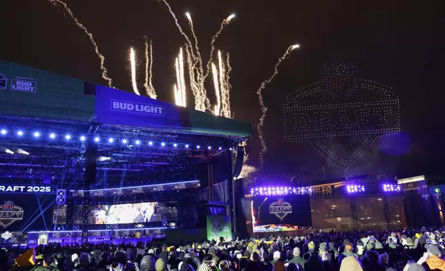 Fans watch a firework and drone show after the third round of the NFL football draft, Friday, April 25, 2025, in Green Bay, Wis. (AP Photo/Matt Ludtke)