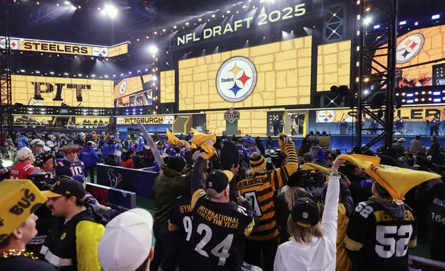 Pittsburgh Steelers fans cheer as their team announces a pick during the third round of the NFL football draft, Friday, April 25, 2025, in Green Bay, Wis. (AP Photo/Matt Ludtke)