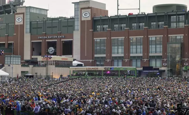 Fans watch during the second round of the NFL football draft, Friday, April 25, 2025, in Green Bay, Wis. (AP Photo/Matt Ludtke)