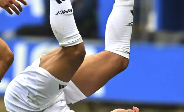 Real Madrid's Kylian Mbappe falls during a Spanish La Liga soccer match between Alaves and Real Madrid at the Mendizorroza stadium in Vitoria, Spain, Sunday April 13, 2025. (AP Photo/Miguel Oses)