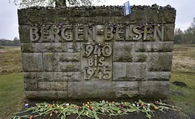 FILE — Flowers and stones are placed for the victims at a memorial stone at the Bergen-Belsen concentration camp in Bergen, northern Germany, April 26, 2015. (AP Photo/Martin Meissner, File)