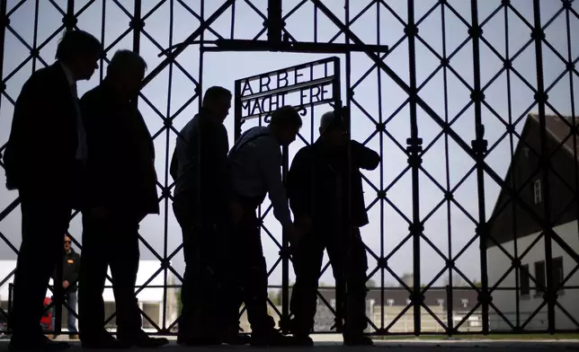 FILE - A Wednesday, April 29, 2015 file photo showing blacksmiths preparing a replica of the Dachau Nazi concentration camp gate, with the writing "Arbeit macht frei" (Work Sets you Free) at the main entrance of the memorial in Dachau, Germany. (AP Photo/Matthias Schrader, File)