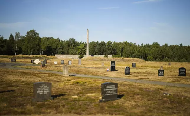FILE — The sun lights memorial stones at the former Nazi concentration camp Bergen-Belsen in Bergen, Germany, Saturday, Sept. 3, 2022. (AP Photo/Markus Schreiber, File)