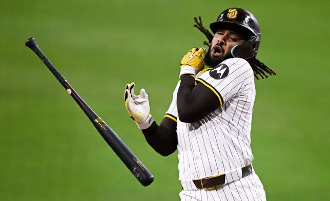 San Diego Padres' Fernando Tatis Jr. (23) is hit with a pitch during the seventh inning of a baseball game against the Chicago Cubs, Monday, April 14, 2025, in San Diego, Calif. (AP Photo/Denis Poroy)