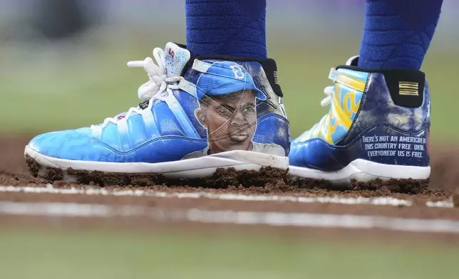 Arizona Diamondbacks' Josh Naylor wears shoes in celebration of Jackie Robinson Day during a baseball game against the Miami Marlins, Tuesday, April 15, 2025, in Miami. (AP Photo/Lynne Sladky)