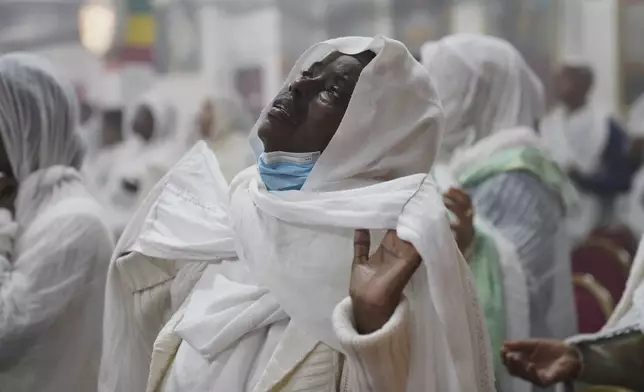 A congregant worships at Re'ese Adbarat Debre Selam Kidist Mariam Church, an Ethiopian Orthodox Tewahedo church, in Washington, D.C., Saturday, April 5, 2025. (AP Photo/Jessie Wardarski)