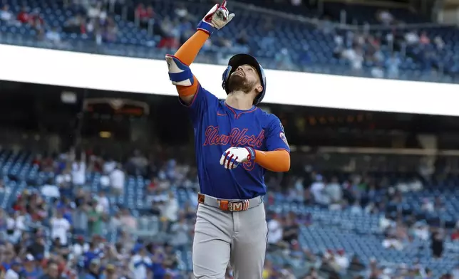 New York Mets' Brandon Nimmo gestures after hitting a grand slam off Washington Nationals pitcher Cole Henry during the seventh inning of a baseball game in Washington, Monday, April 28, 2025. (AP Photo/Terrance Williams)